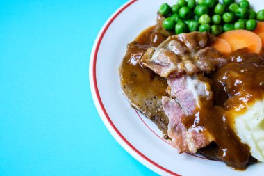 Londra İngiltere 26 Haziran 2025, Classic Liver ve Bacon yanında patates püresi havuç ve soğan sosu.