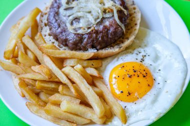 Londra İngiltere 27 Haziran 2025, Ev yapımı jambon veya soğanlı sığır burger ve kızarmış yumurta