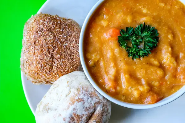 Londra İngiltere, 16 Temmuz 2025, Bir kase sıcak mercimek çorbası Maydanozlu ekmek rulosu