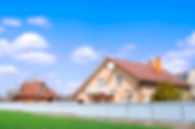 Bahçesi çitlerin arkasında olan özel bir banliyö evi. Yeşil thuja çitli ekolojik alanda bir kır evi. Modern mimari, zenginlik ve lüks, bulanık arka plan