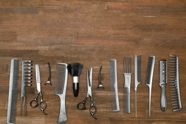Professional Set of different hairdressing brushes or combs, scissors, comb collection, hair tools in row, beauty, fashion, creating a hairstyle concept. Flat lay close up, copy space.