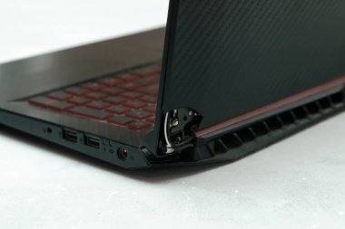 Laptop is broken with arm hinge on the screen,laptop cover,repair loop. cracked plastic laptop split case. computer technology equipment maintenance service concept.