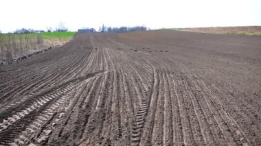 Plowed agricultural field ready for seed sowing, planting crops.Newly ploughed field with furrows. Sunny countryside lanscape.cultivating and make soil tillage, nature countryside rural.