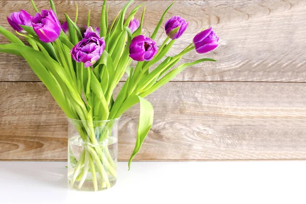 stock image Violet purple tulips colorful bouquet in vase. Beautiful tenderness flowers macro.Spring floral romantic gift card wooden background.Flower shop florist design ,Womens,Valentines,Mother day concept.