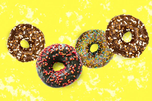 Flying falling levitating floating brown sweet sugar glazed doughnuts,tasty donuts in air on yellow spotted painted abstract background.Creative dessert food.Trendy,healthy unhealthy nutrition,mockup.