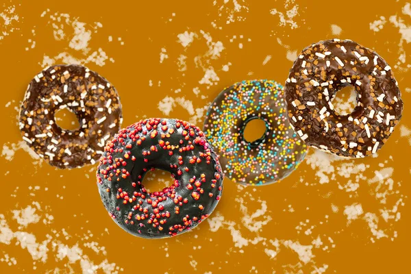 Flying falling levitating floating brown sweet sugar glazed doughnuts,tasty donuts in air on spotted painted abstract background.Creative dessert food.Trendy,healthy unhealthy nutrition,mockup.