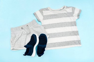 Summer babies gray clothes and accessories with t shirt, shorts,sneakers. Modern fashion kids casual outfit.Set of children's clothing for spring. Flat lay, top view,overhead,mockup.