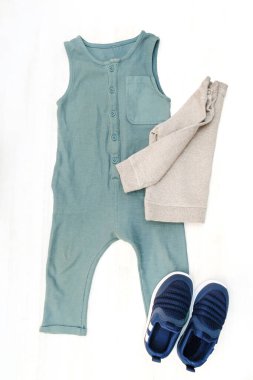 Cute baby romper,bodysuit,sneakers with jumper. Set of kids,childrens clothes and accessories in pastel blue gender neutral color. Newborn,infant fashion, outfit. Flat lay, top view,mockup.