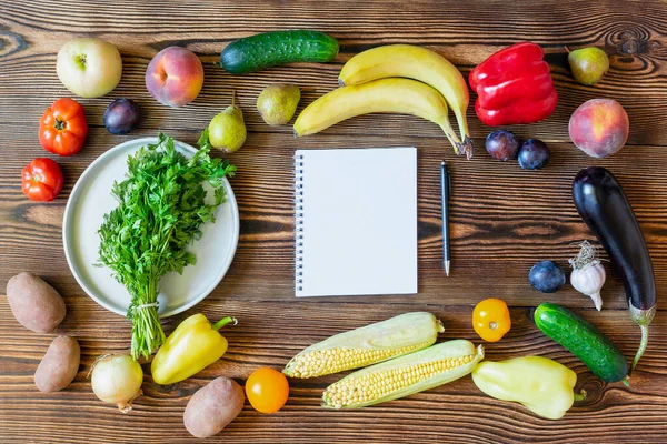 新鮮な果物や野菜と夕食のためのダイエットフィットネス菜食主義者の食べ物 ノートブックとペンで痩身計画木製の背景上のビューのコピースペースフレームフラットフラットレイアウト上のノートのための — ストック写真