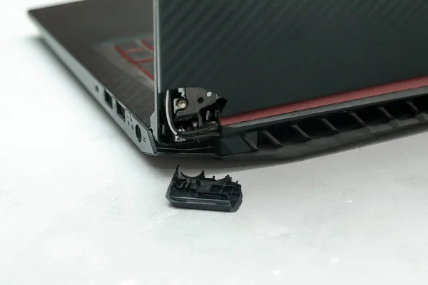Laptop is broken with arm hinge on the screen,laptop cover,repair loop. cracked plastic laptop split case. computer technology equipment maintenance service concept.