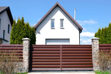 private suburban house with backyard behind high fence. beautiful landscape recreation cottage complex in ecological area with green thuja hedge. Modern architecture, riches and luxury concept.