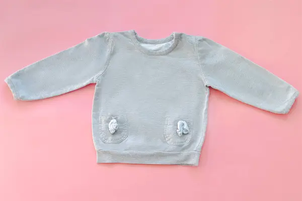 Stock image Warm gray jumper,sweater,purse,little bag.Set of baby childrens clothes,clothing for spring,autumn,winter on pink background.Casual fashion girls kids outfit.Flat lay,top view,mockup.