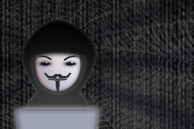 A fraudster with a laptop is connected to the dark web with the job of obtaining personal data illegally. Guy Fawkes mask representation.
