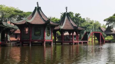 Sakin bir göl üzerindeki geleneksel pavyonların manzarası