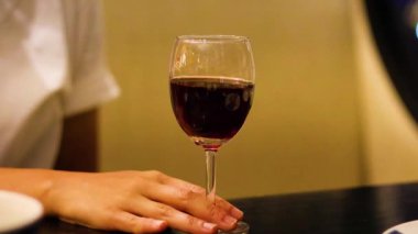 Masada şarap kadehini tutan el.