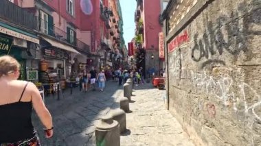 Yoğun bir sokak pazarında yürüyen turistler