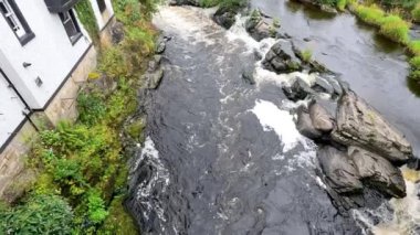 Llangollen, Galler 'deki binaların yanında akan dere