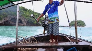 Manzaralı Krabi sahil şeridinde gezinen bir tekne.