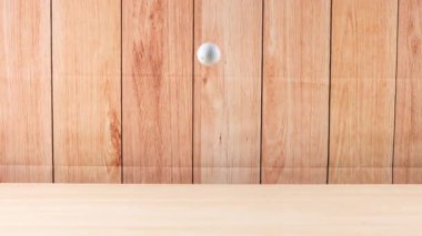 Bir golf topu ahşap zeminde yuvarlanır.