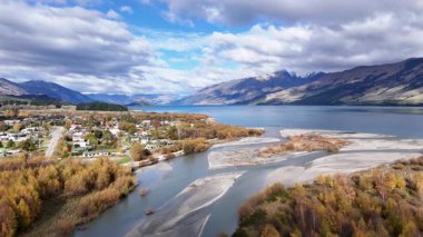 Hava görüntüleri Glenorchy 'nin çarpıcı manzarasını canlı sonbahar yaprakları, dolambaçlı nehirler ve dinamik gökyüzü altında görkemli dağlarla yakalar.