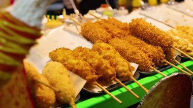 Lezzetli mısır sosislileri gece pazarında sergileniyor.