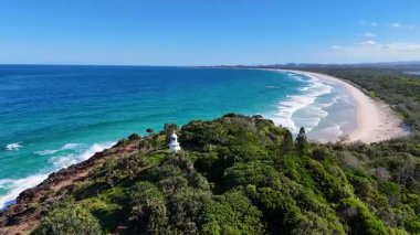 Yeşillik ve okyanus dalgalarına tepeden bakan deniz feneri