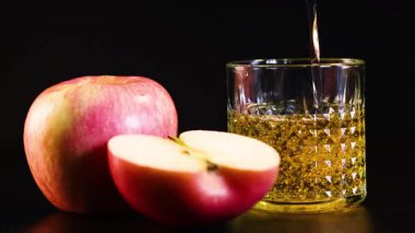 Elma suyu bütün ve dilimlenmiş elmaların yanına döküldü.