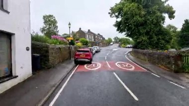 Bir araba yerleşim yerindeki bir caddeden geçiyor.