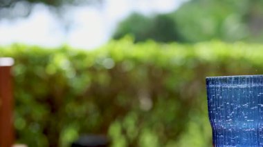 Yeşil arka planlı, köpüklü içeceğe saman yerleştirmek