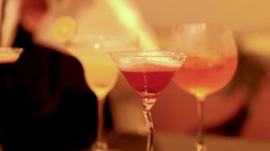 Barmen kokteylleri limon dilimleriyle süslüyor.