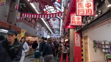 Hareketli kalabalık bir alışveriş salonu.