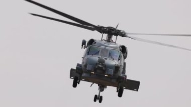 Bir Kara Şahin helikopteri Geelong, Avustralya 'daki Avalon Hava Gösterisi' nde bulutlu gökyüzünde dinamik manevralar gerçekleştiriyor.