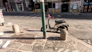 Napoli caddesinde scooter ve çöp kutuları.