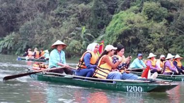 Turistler manzaralı bir tekne yolculuğunun tadını çıkarırlar.