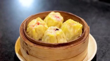 Bambu buharlı bir sepetteki Dim sum köfteleri.