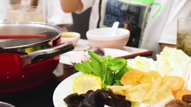 Arkadaşlar birlikte yemek pişirir ve güveç paylaşırlar.