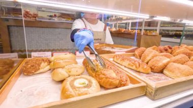 Melbourne, Avustralya 'daki fırında taze hamur işleri servis eden kişi.