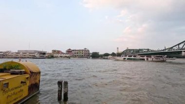 Tekne Bangkok köprüsü yakınlarındaki nehir boyunca seyahat ediyor.