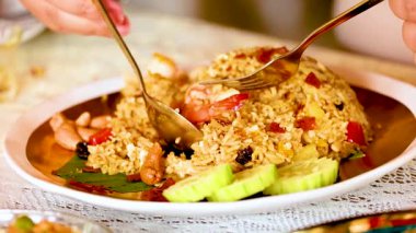Savoring delicious shrimp fried rice with cucumbers