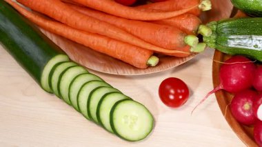 A vibrant assortment of fresh vegetables arranged artistically, showcasing a variety of colors and textures under bright lighting