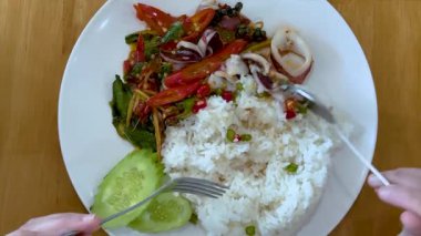 Eating a flavorful meal with utensils