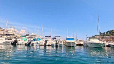 Boats docked in Monte Carlo harbor, sunny day