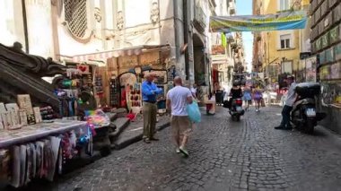 People shopping and walking in a busy street market