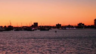 Sunset view of marina and city skyline