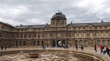 Visitors wander around a grand European courtyard