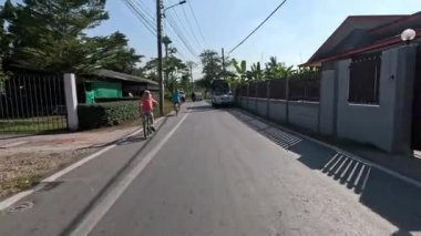 Cyclist navigating through a quiet suburban area