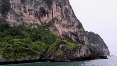 Boat journey showcasing Krabi's lush landscapes and ocean