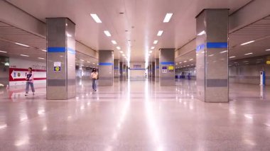 A serene Bangkok MRT station with minimal foot traffic, showcasing modern architecture and bright lighting