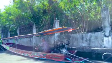 Colorful boats navigate Bangkok's floating market canals