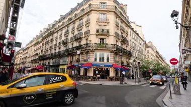 Time-lapse of traffic and pedestrians at a city crossroad